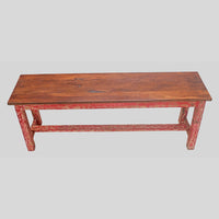 Vintage handcrafted long wooden bench with distressed red finish, side view