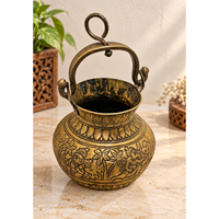 Antique brass holy water pot with engraved floral and traditional figures, front view