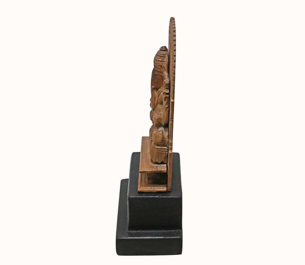 Antique hand-carved wooden Lord Ganesha statue, side view