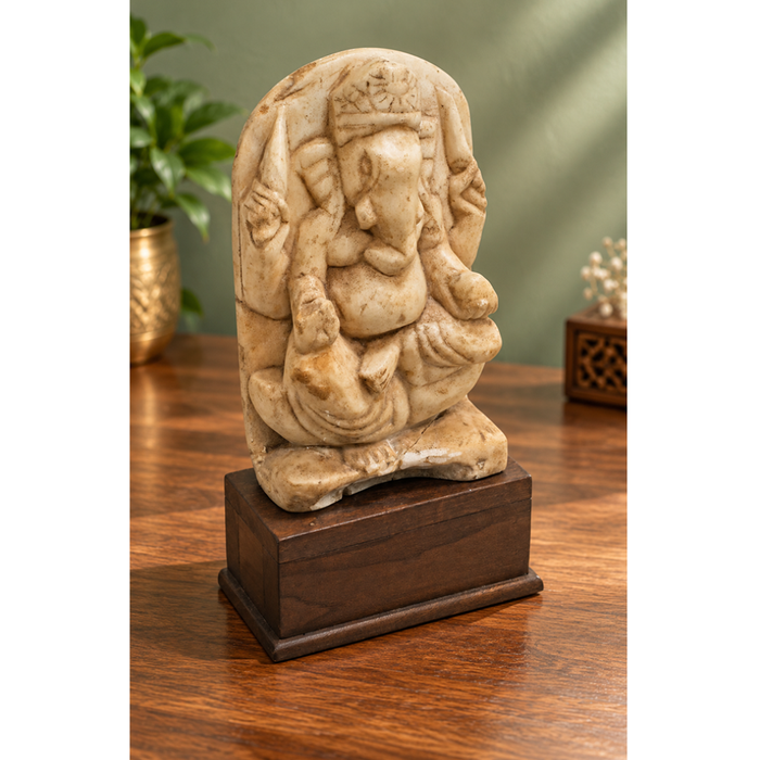 Vintage marble Hindu Lord Ganesha statue on wooden base, front view