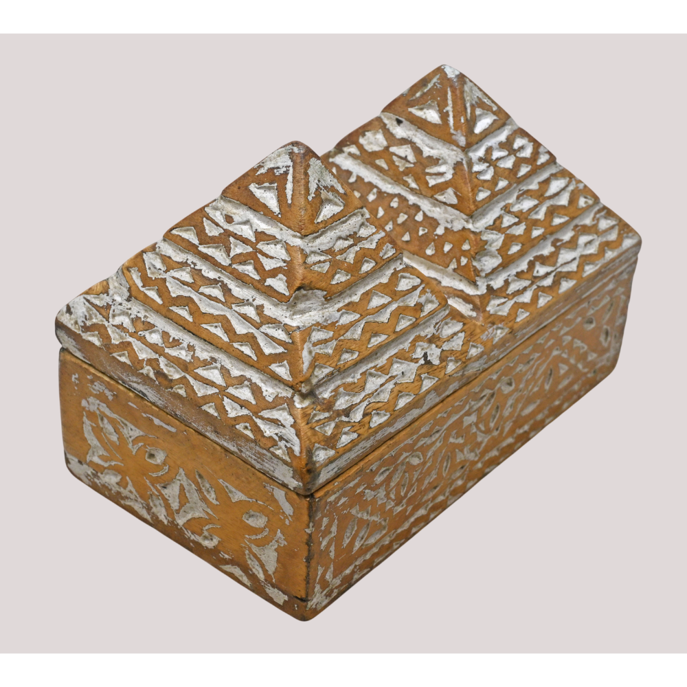 Handcrafted tribal wooden jewelry box with pyramid lid and carved details, angled view