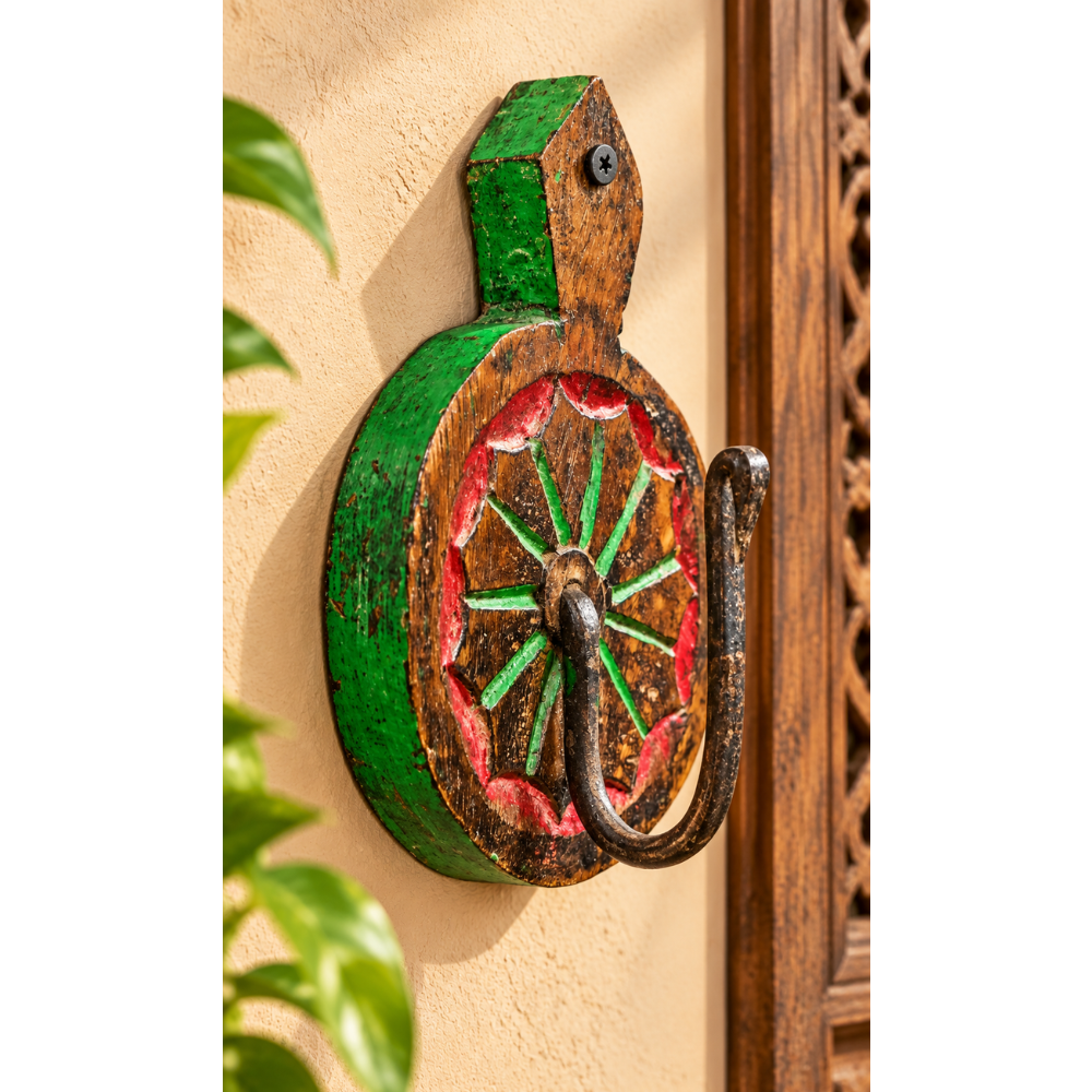 Carved teak wood wall key holder with floral sunburst and iron hook, front view