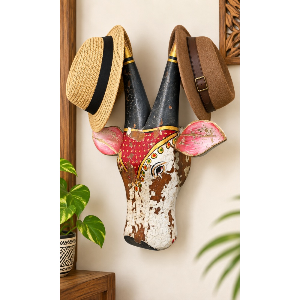 Red and white painted wooden cow head wall hat hanger, front view