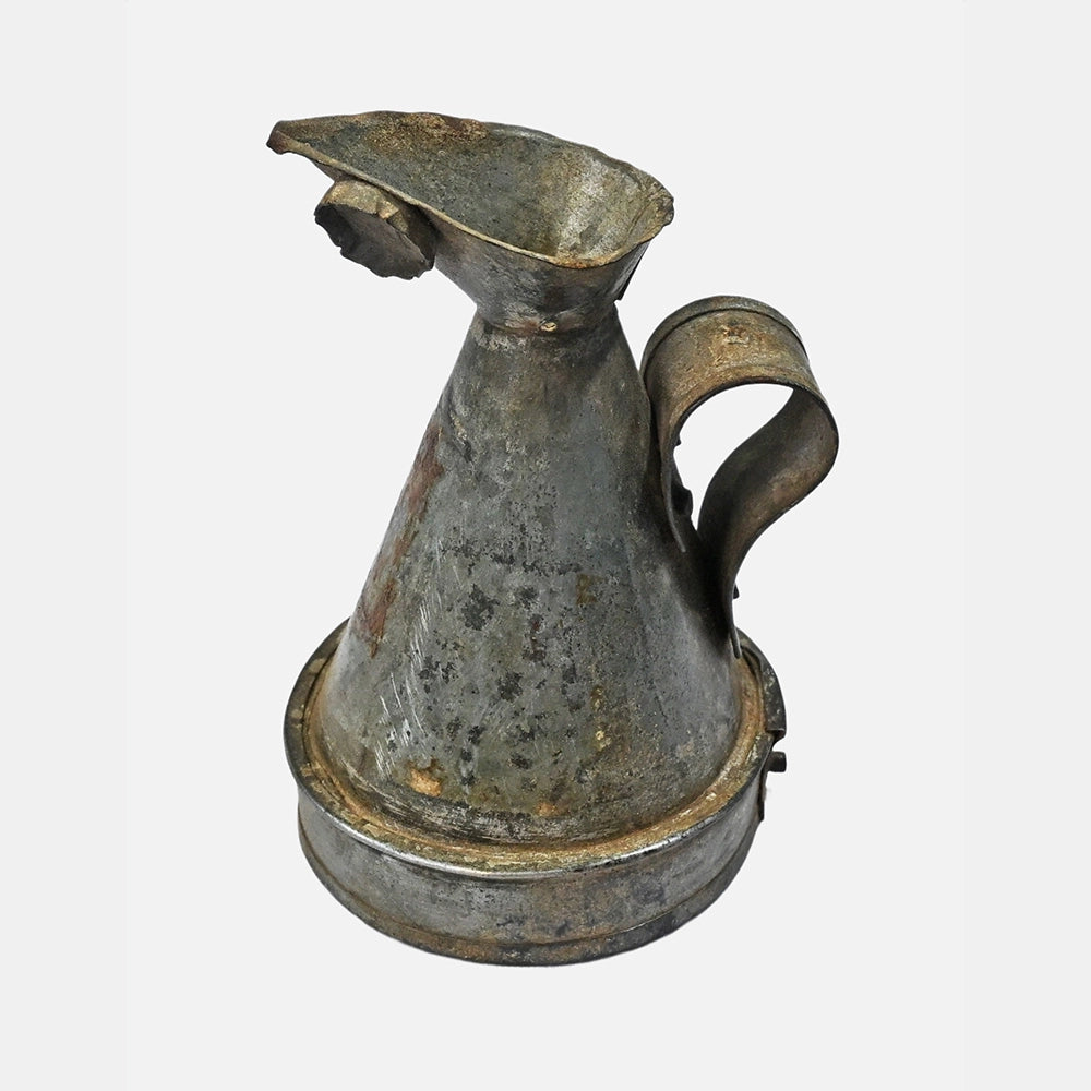Side view of handcrafted iron measuring pot