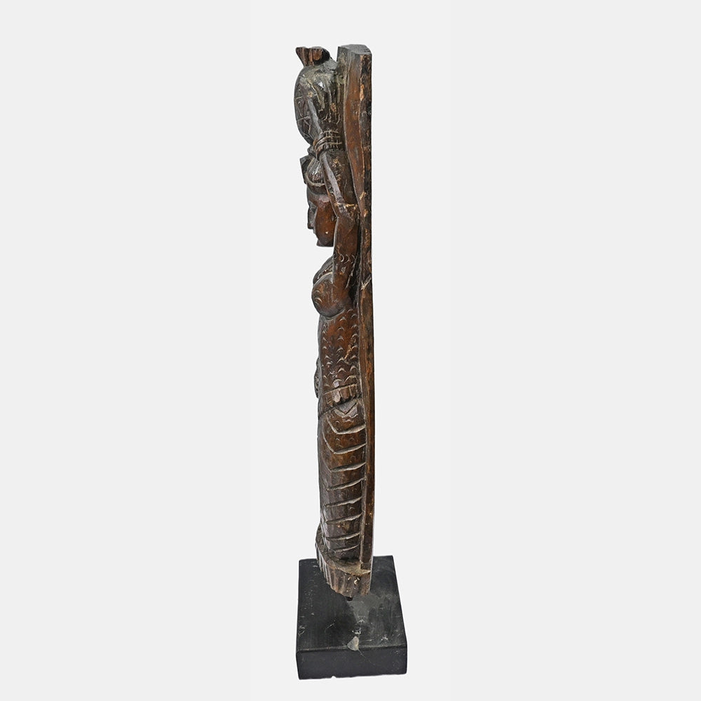 Close-up of carved details on handcrafted wooden figurine
