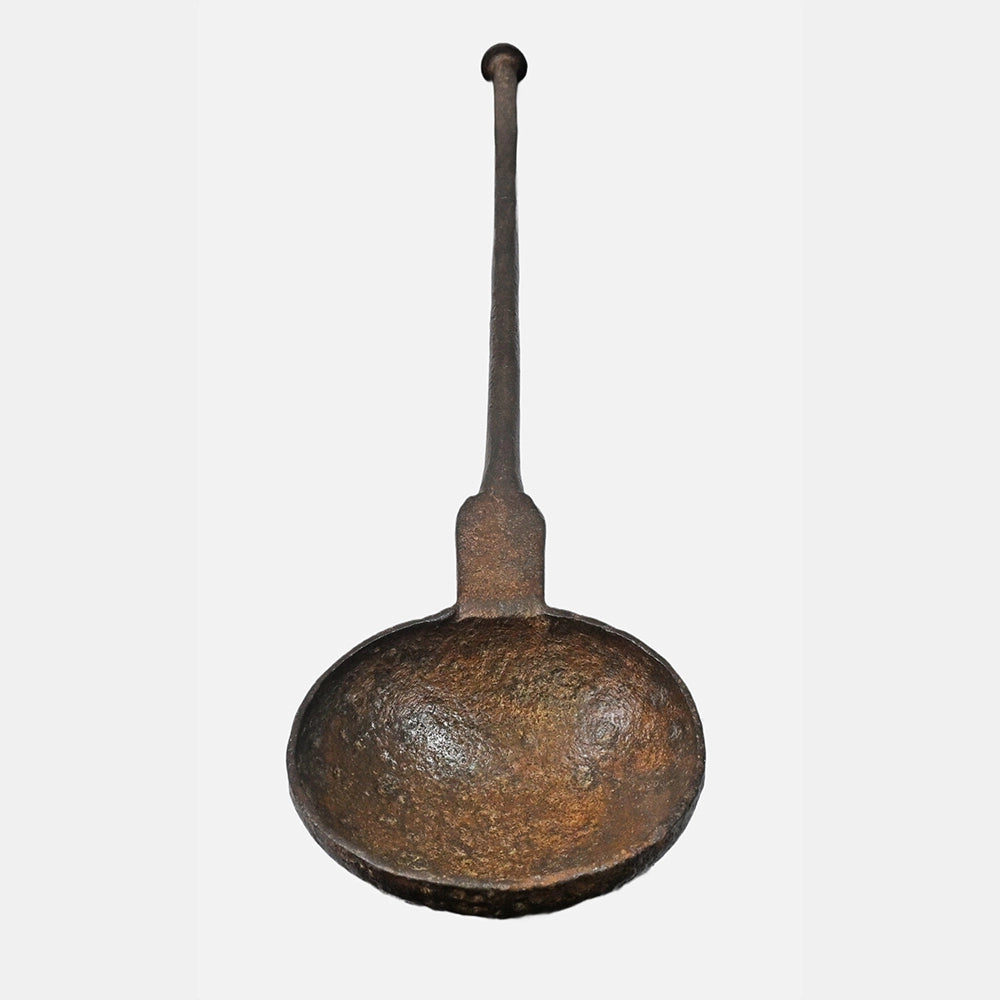 Close-up detail of hand-forged iron cooking spoon