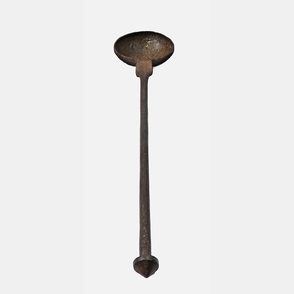 Side view of antique metal cooking spoon