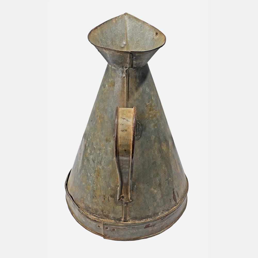 Side view of vintage iron measuring pot
