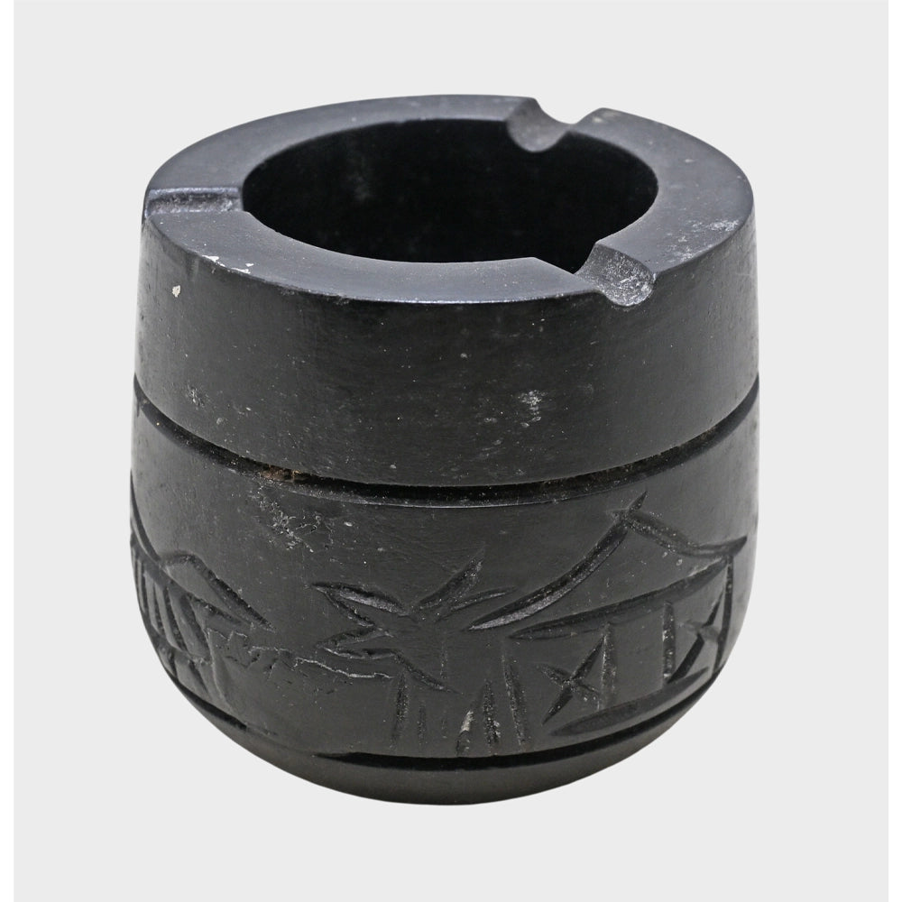 Close-up of handcrafted black stone ash holder surface