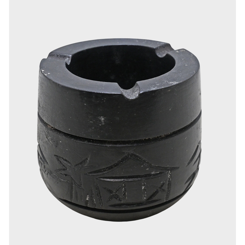 Angled view of cylindrical black stone cigar ash holder