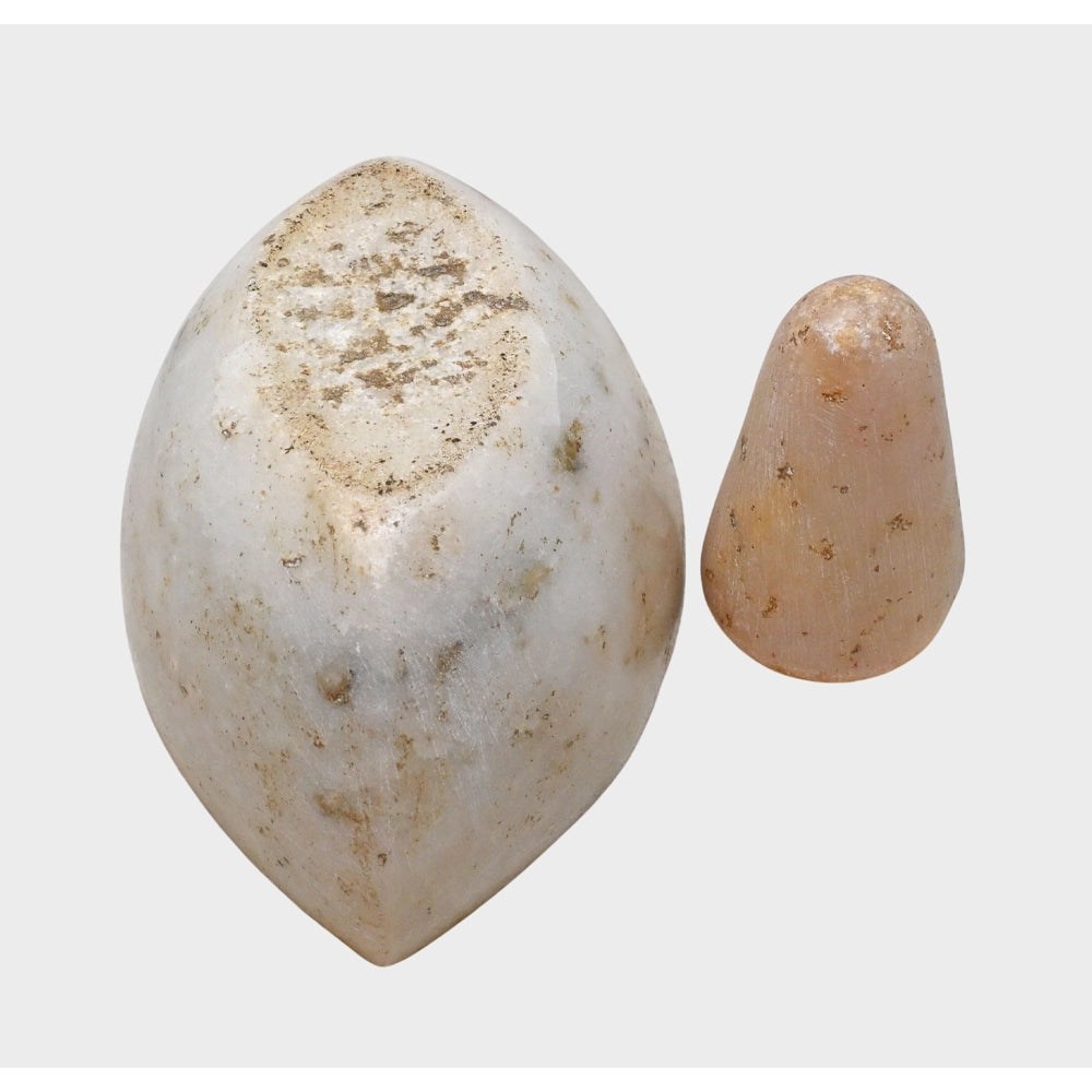 Angled view of white marble herbal spice grinder