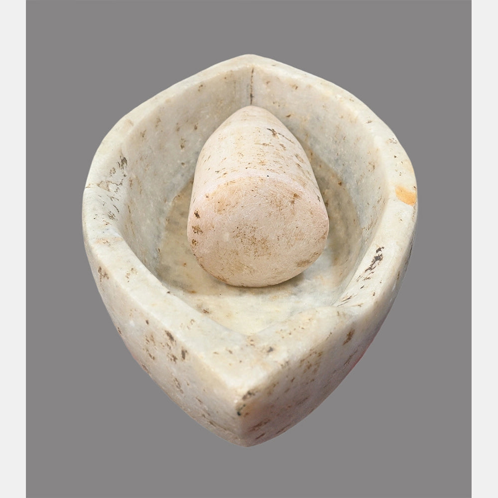 Angled view of white marble mortar and pestle set