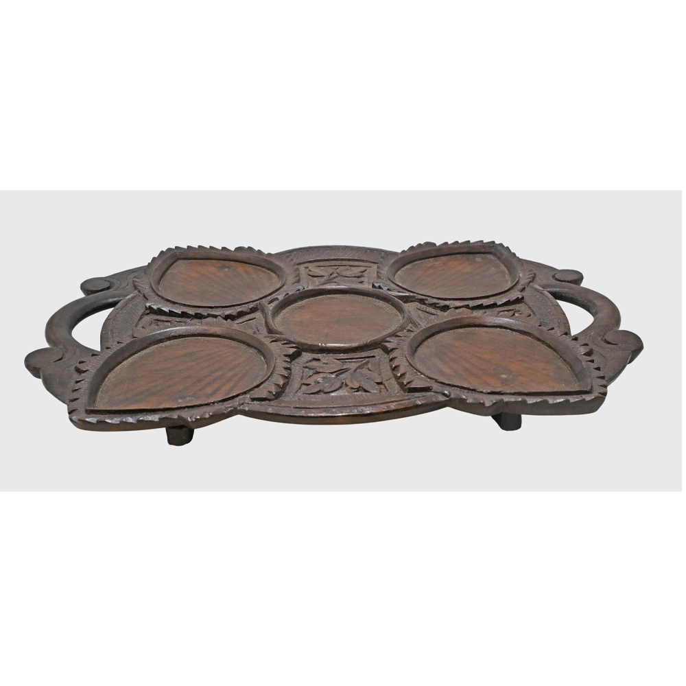 Close-up of leaf-shaped bowls on teak serving tray