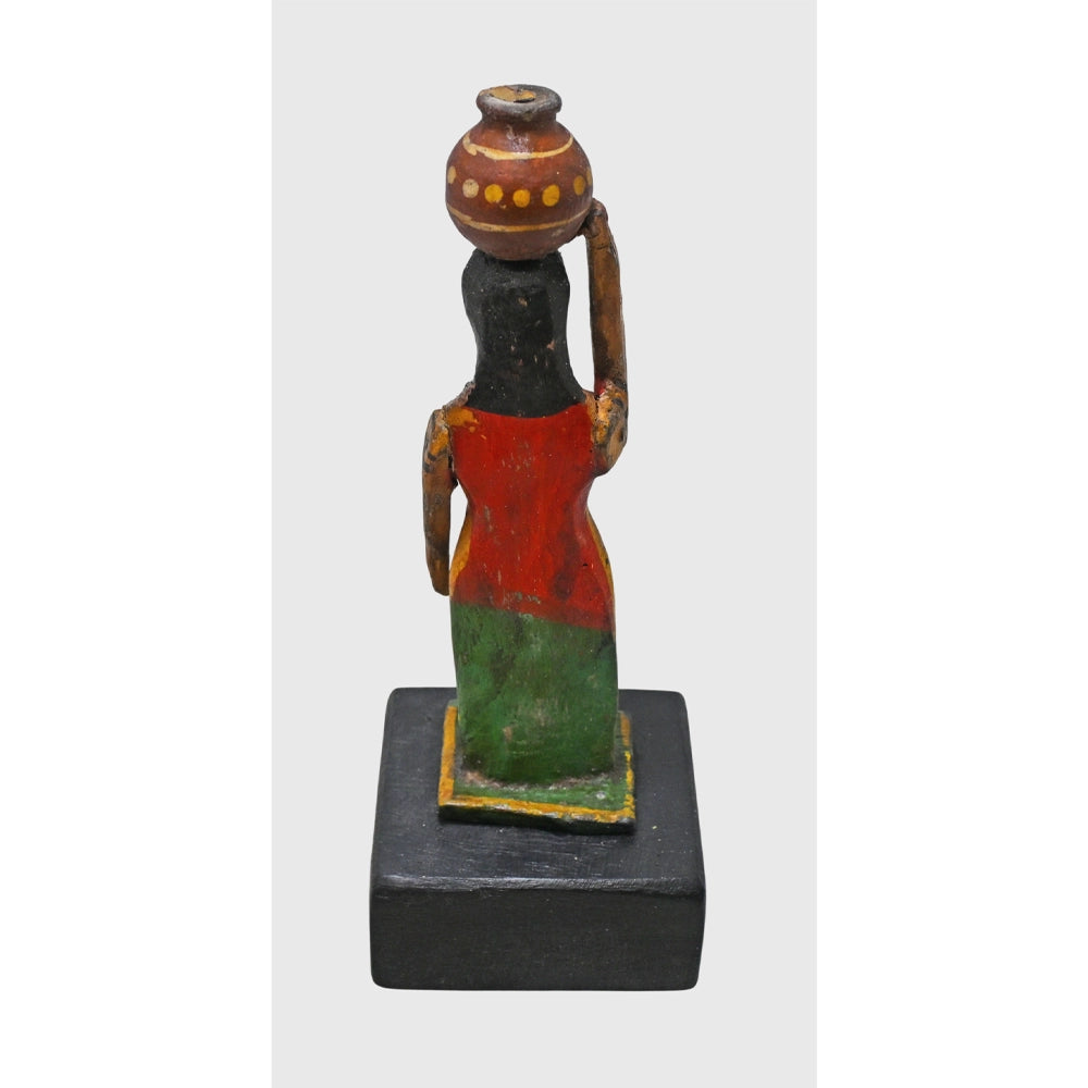 Side view of handcrafted wooden lady carrying matka