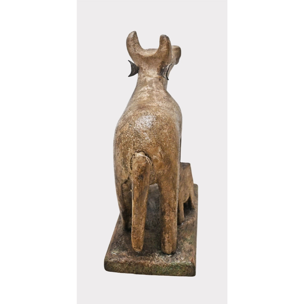 Side view of wooden Nandi cow with baby calf