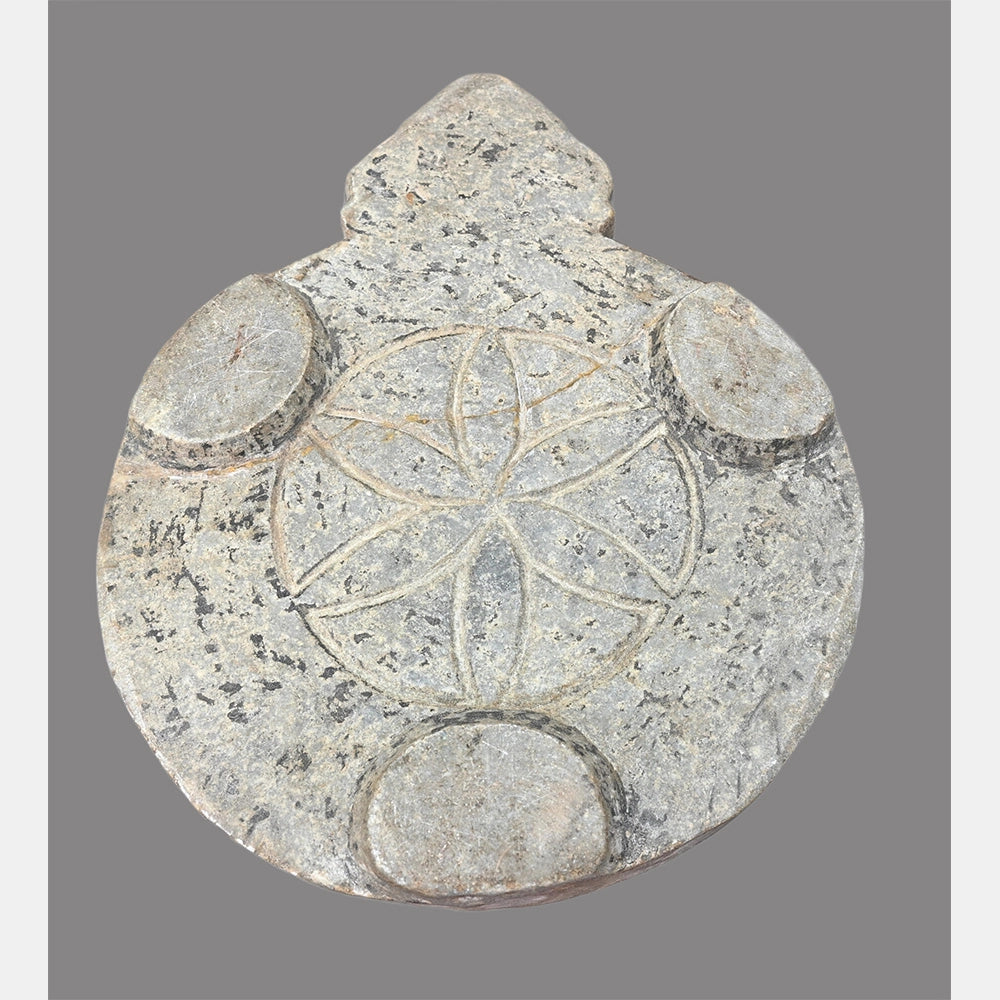 Angled view of handcrafted marble chapati plate
