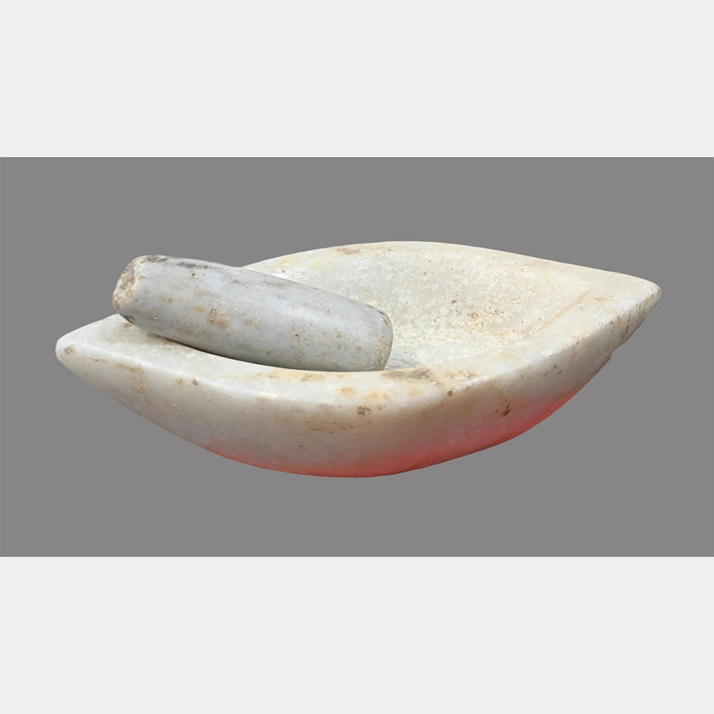 Boat-shaped white marble mortar and pestle showing its shape