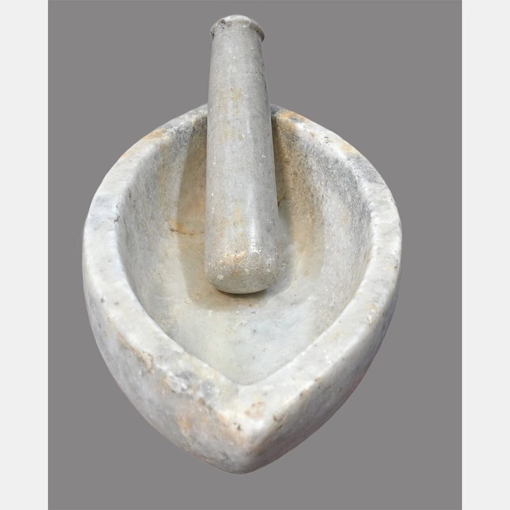 Close-up of handcrafted white marble grinding set
